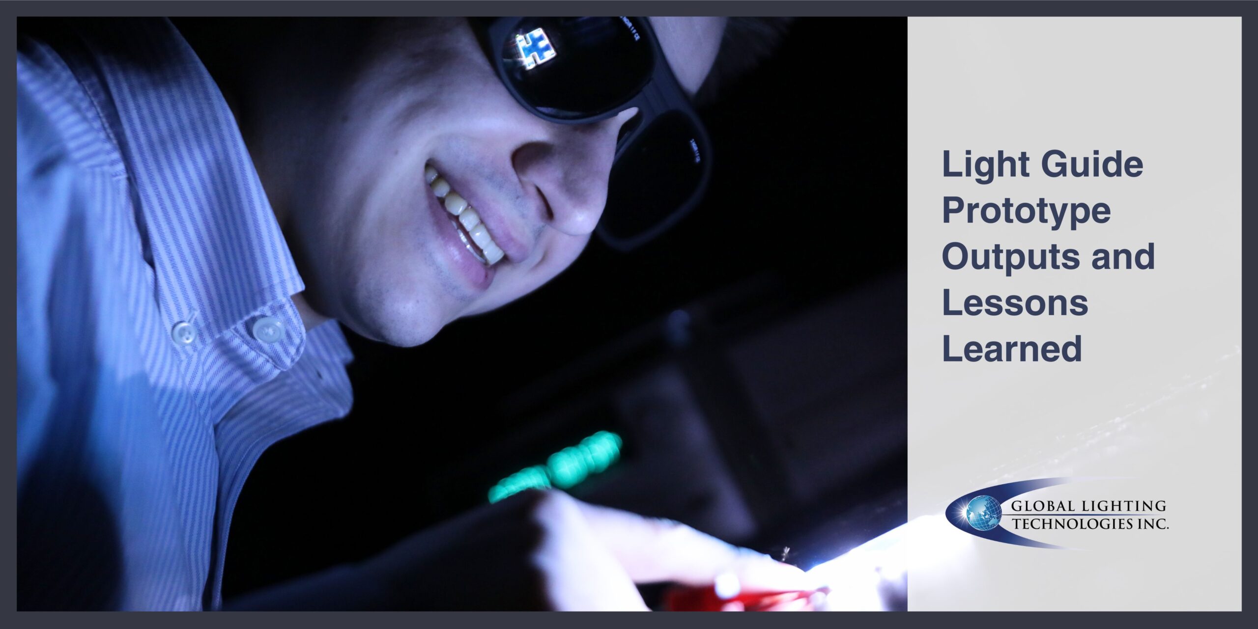 An engineer solders pieces of a light guide prototype together while wearing safety glasses.