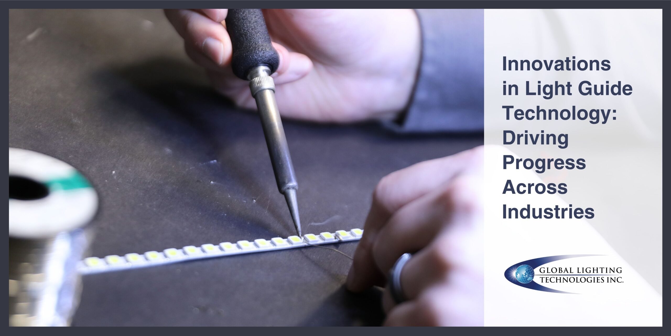 An engineer's hands sit on a table and hold a soldering tool agains a light guide component.  